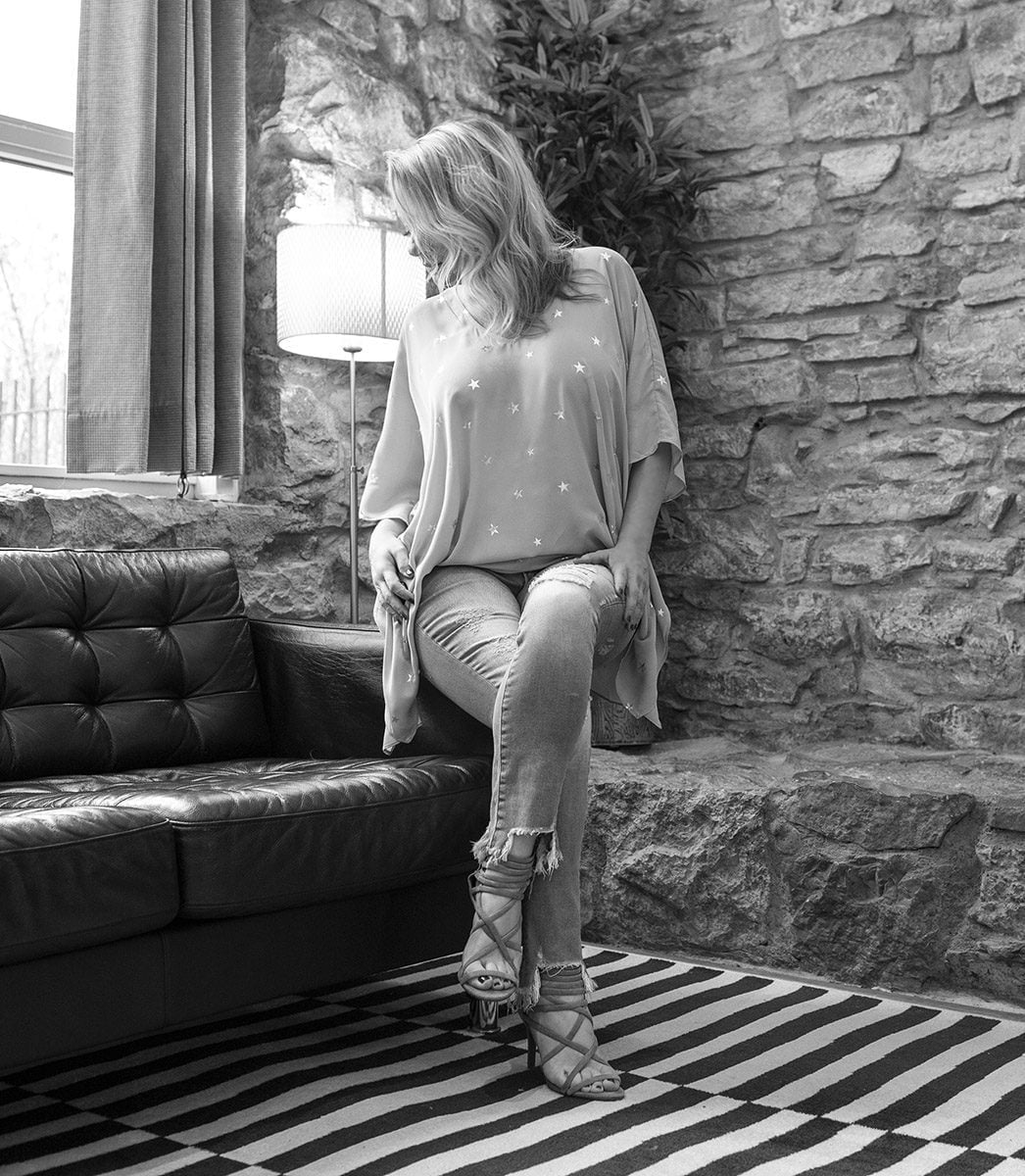 Megan Love, black and white image, wearing jeans and blouse