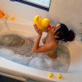 Relaxing in the tub and getting clean after a long day.