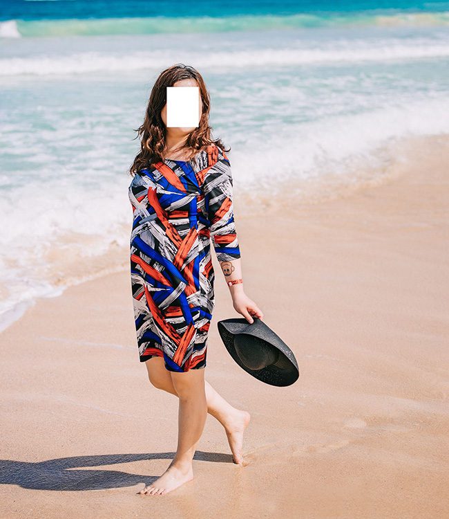 McKenzie Gold, an Asian escort in Minneapolis, MN, walking on the beach